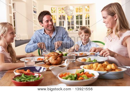 Picture or Photo of Happy family having roast chicken dinner at table