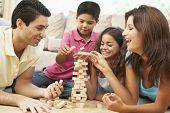 stock photo of game  - Family Playing Game Together At Home - JPG 