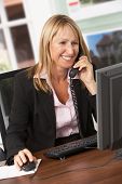 pic of agent  - Female Estate Agent Talking On Phone At Desk - JPG 
