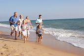 image of beach  - Portrait Of Three Generation Family On Beach Holiday - JPG 