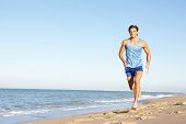 image of fitness  - Young Man In Fitness Clothing Running Along Beach - JPG 