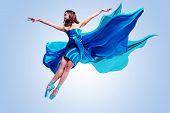 picture of grace  - Beautiful ballet dancer with flowing blue fabric dancing with grace in studio - JPG 