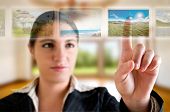 pic of future technology  - Young successful woman planning her vacations choosing options from digital touching screen - JPG 
