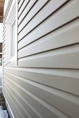 stock photo of windows  - Wall of the house finished in vinyl siding and window - JPG 