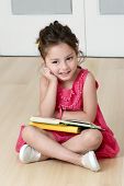 stock photo of kindergarten  - preschooler with book in kindergarten - JPG 