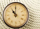 image of tick tock  - Clock with Roman numerals on cord background - JPG 
