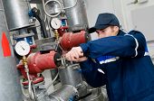 stock photo of pressure  - maintenance engineer checking technical data of heating system equipment in a boiler room - JPG 