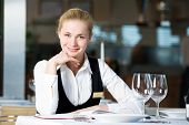 stock photo of restaurant  - Happy beautiful restaurant manager woman administrator at work place - JPG 
