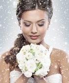 pic of attractive  - Young attractive bride with the bouquet of white roses over snowy Christmas background - JPG 
