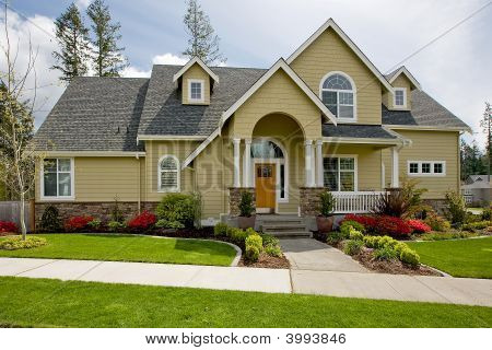 Picture or Photo of Luxury home exterior with grass and blue sky