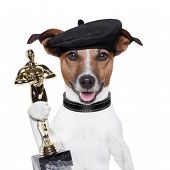 foto of industrial  - award winner director dog holding a statue - JPG 